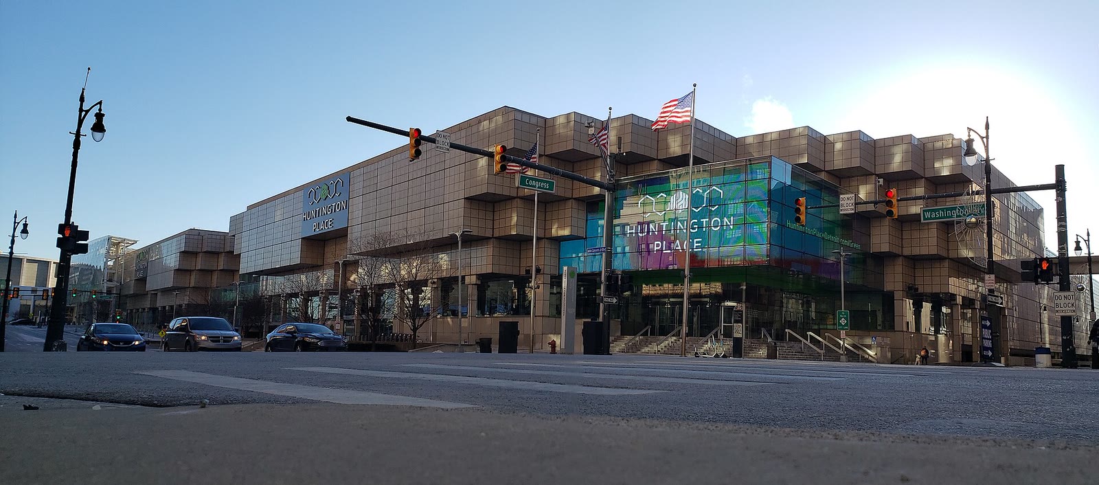 Huntington Place convention center in downtown Detroit, with its name on the corner sign and the glass atrium